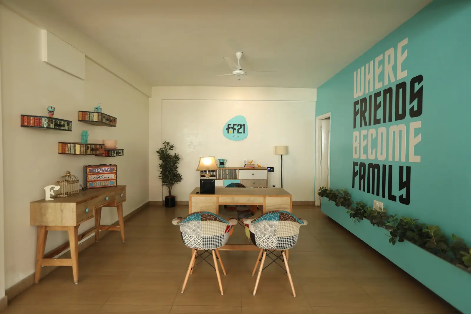 Café corner under a "Where friends become family" wall