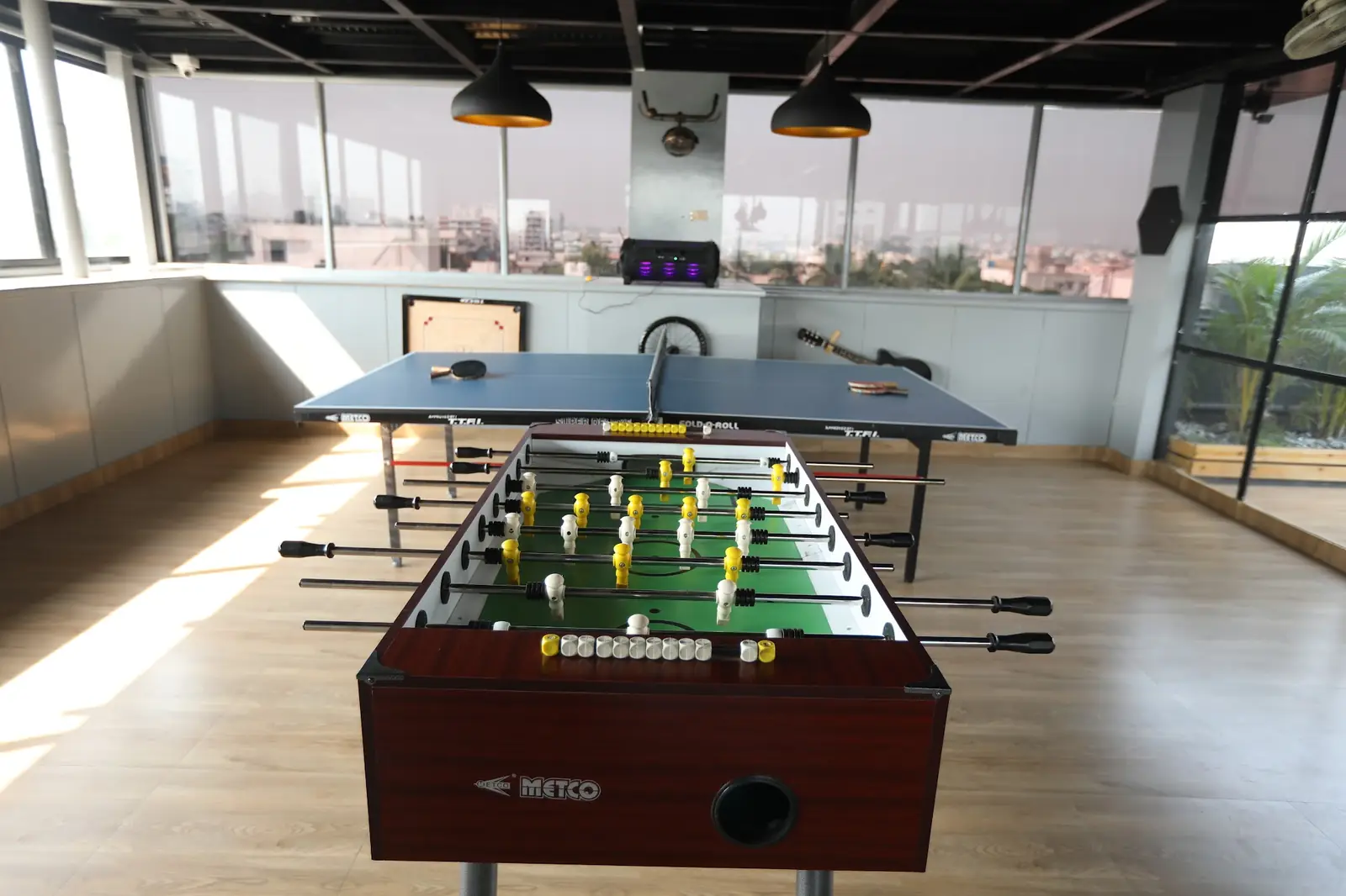 Foosball and table tennis by the windows