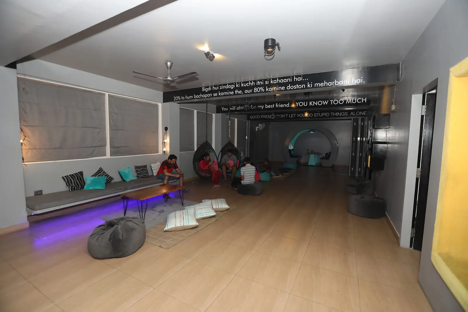 Lounge with swing chairs and floor cushions