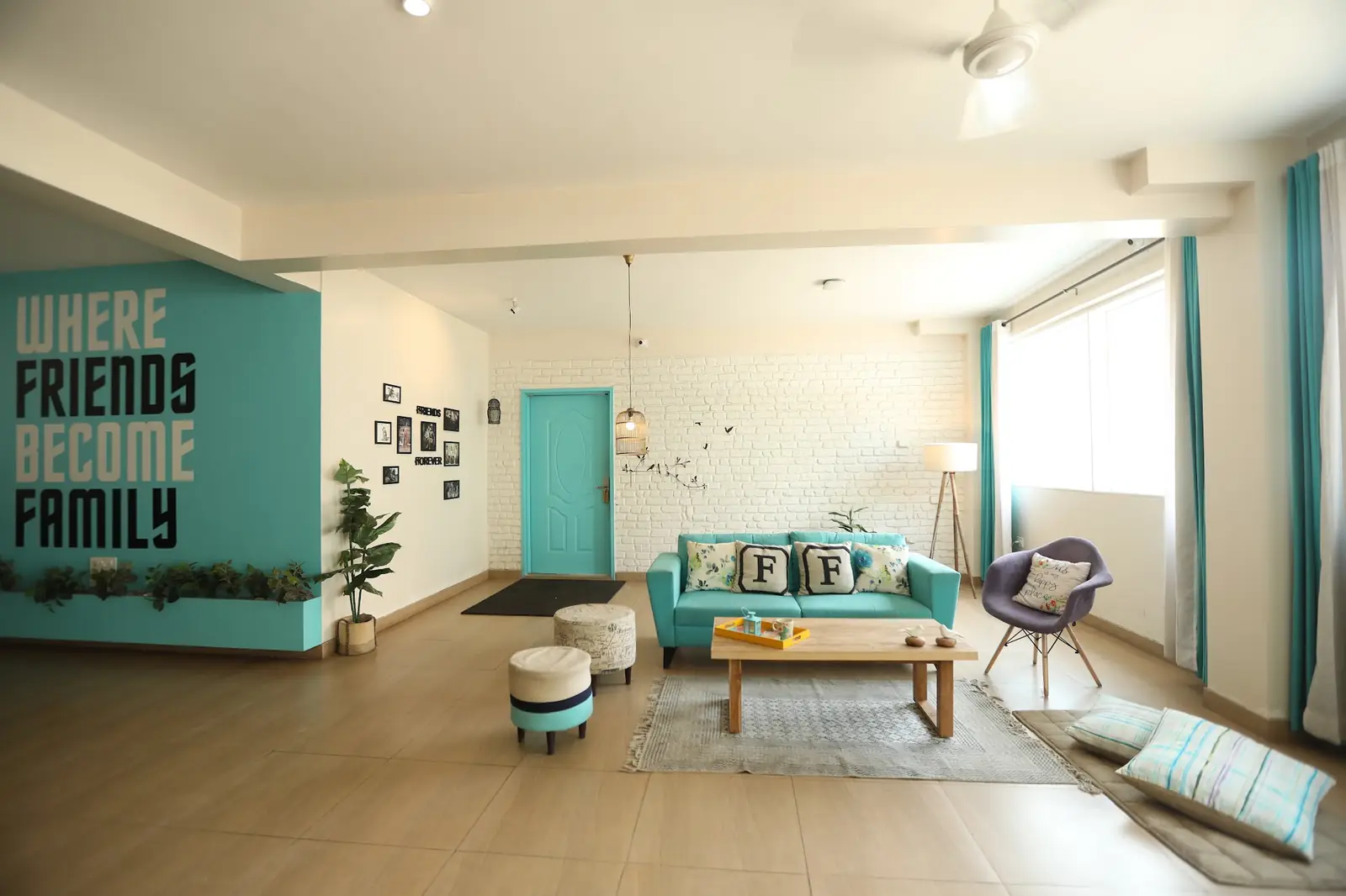 Common room with a "Where friends become family" wall