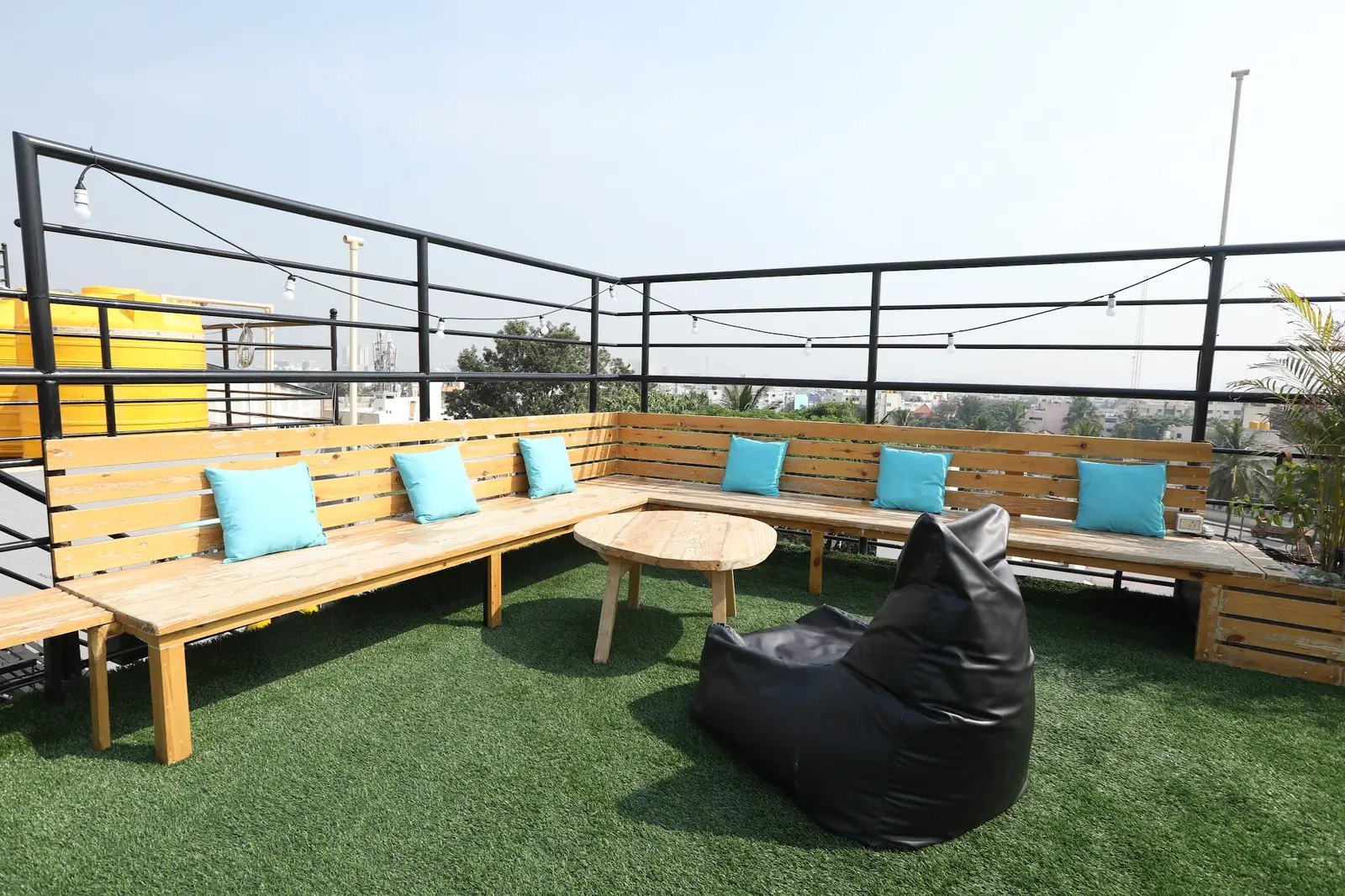 Rooftop lawn with wooden benches and bean bags