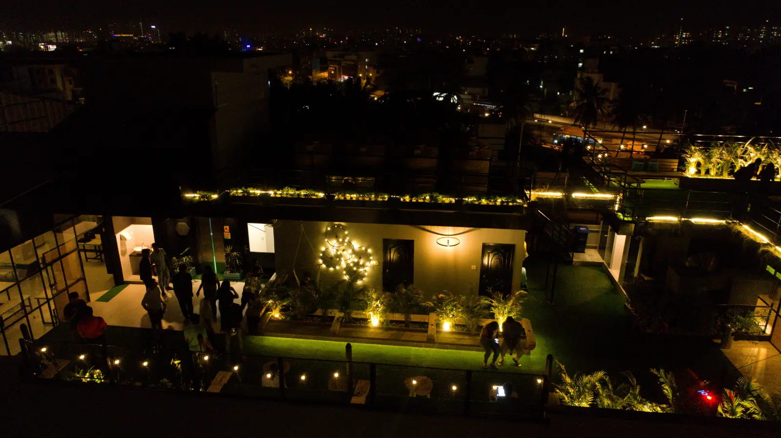 The rooftop lit up at night, seen from above