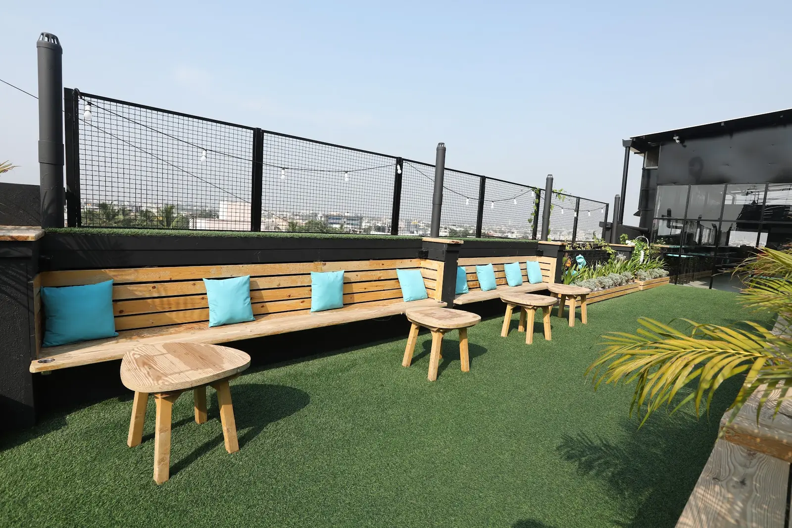Rooftop seating with teal cushions