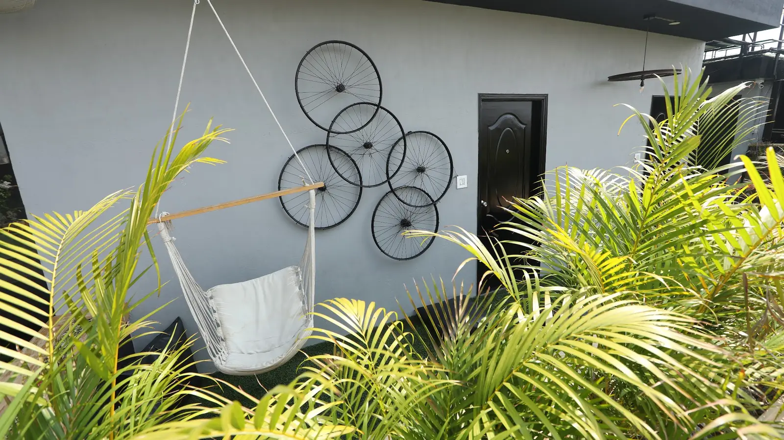 Hanging swing chair among plants on the rooftop