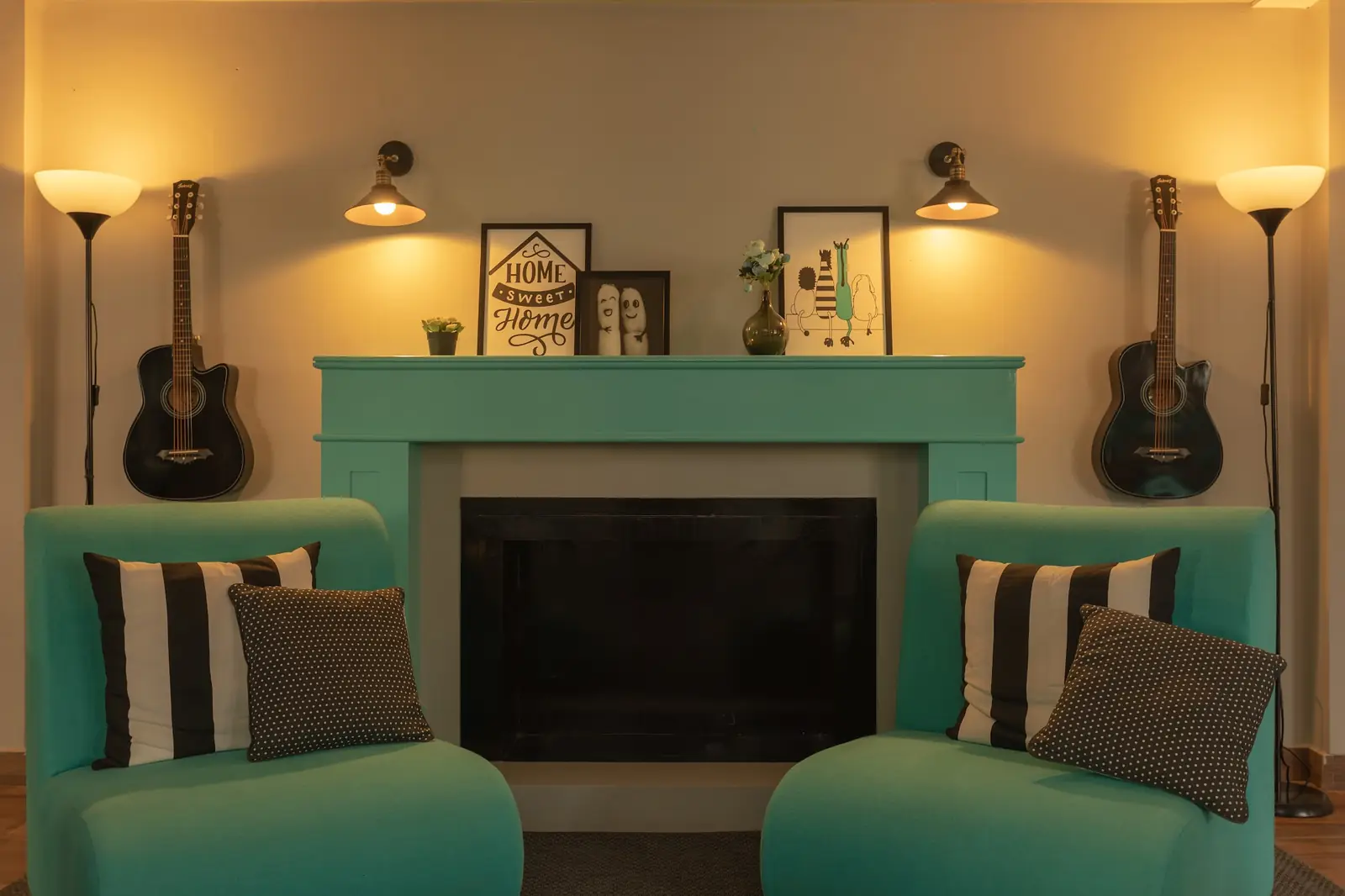 Lounge with a fireplace, guitars and teal armchairs