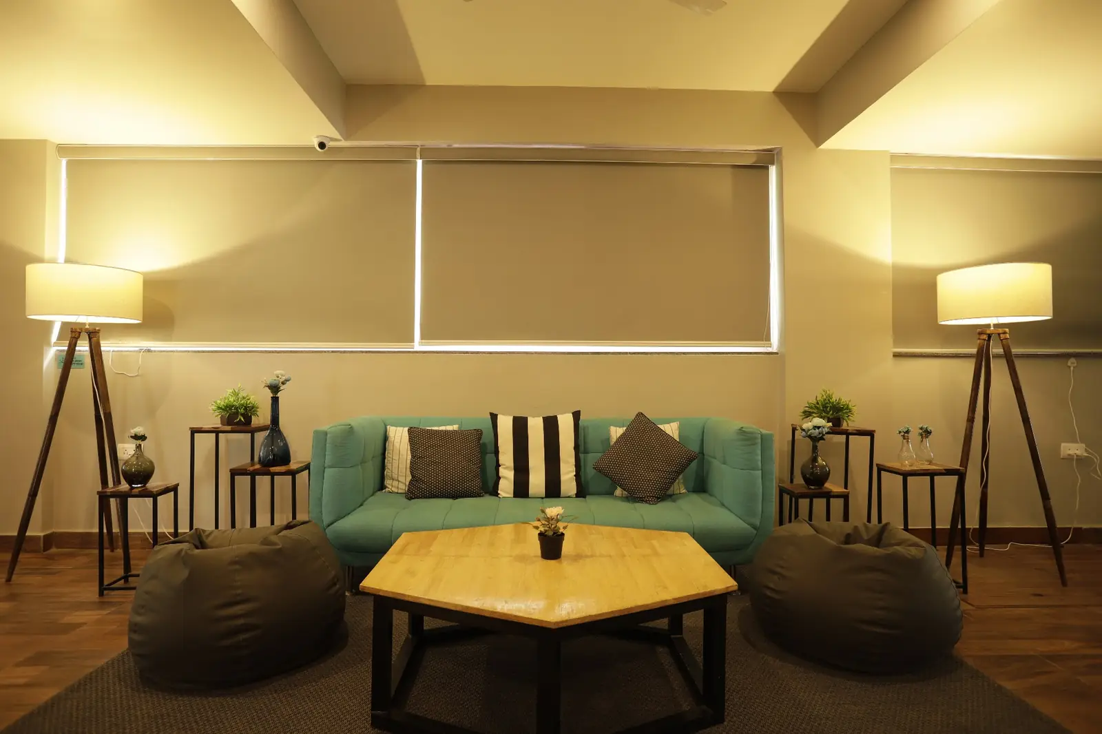 Lounge with a teal sofa, bean bags and floor lamps