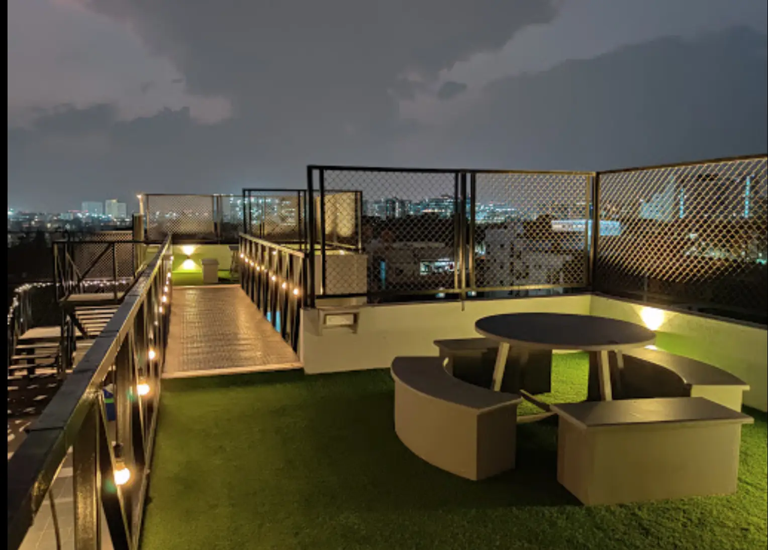 Rooftop terrace with lights at night