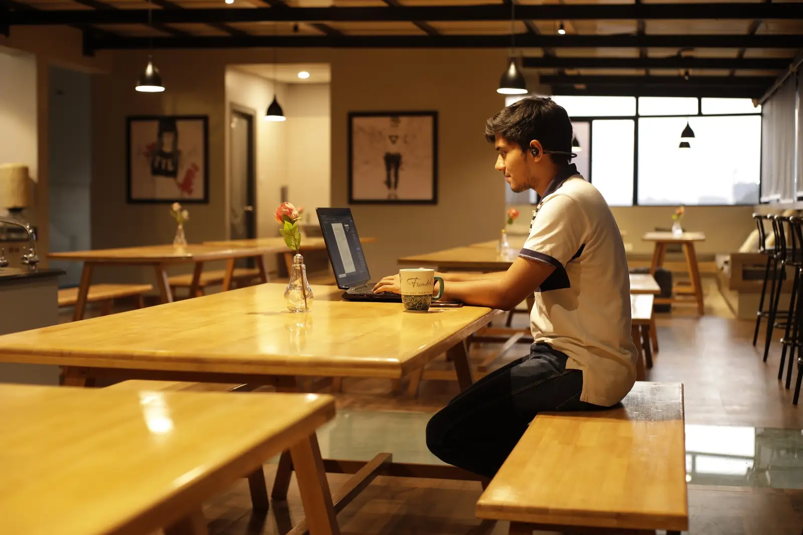 Resident working on a laptop at a wooden table