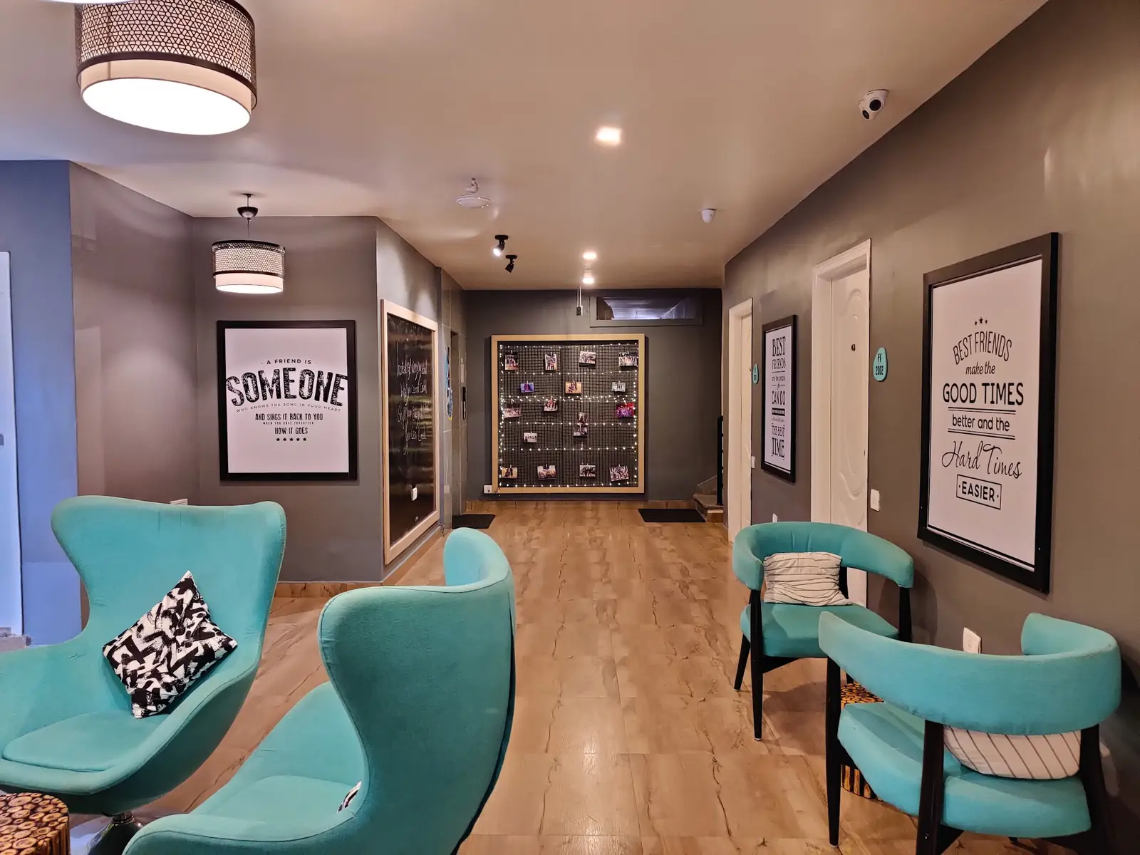 Lounge with teal chairs and framed posters