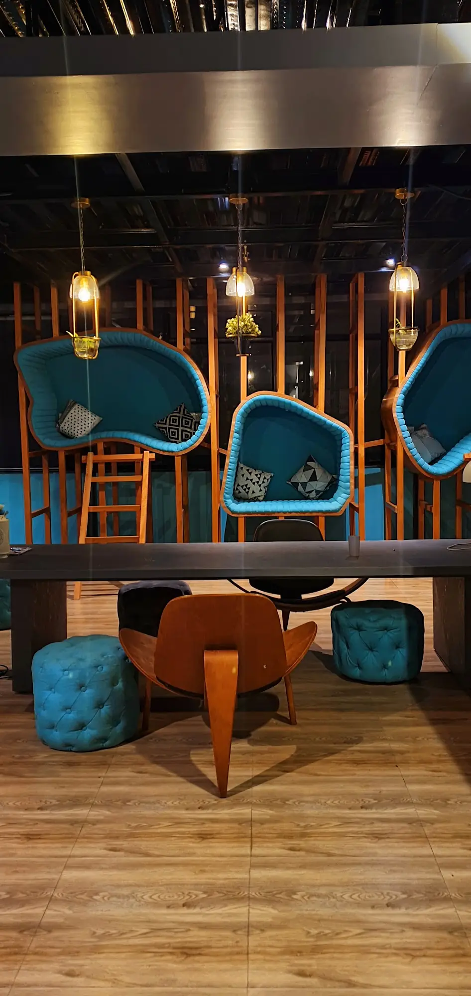 Teal pod chairs on a wooden frame
