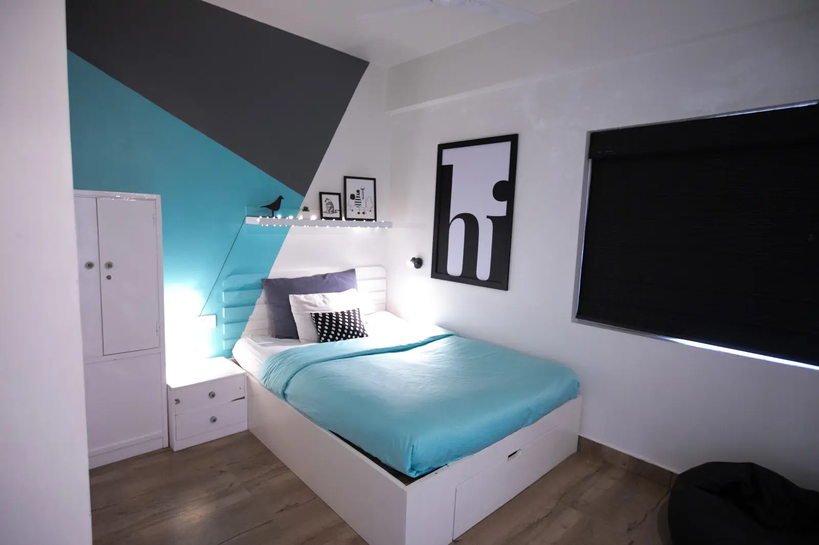 Private room with a single bed and a large "hi" print