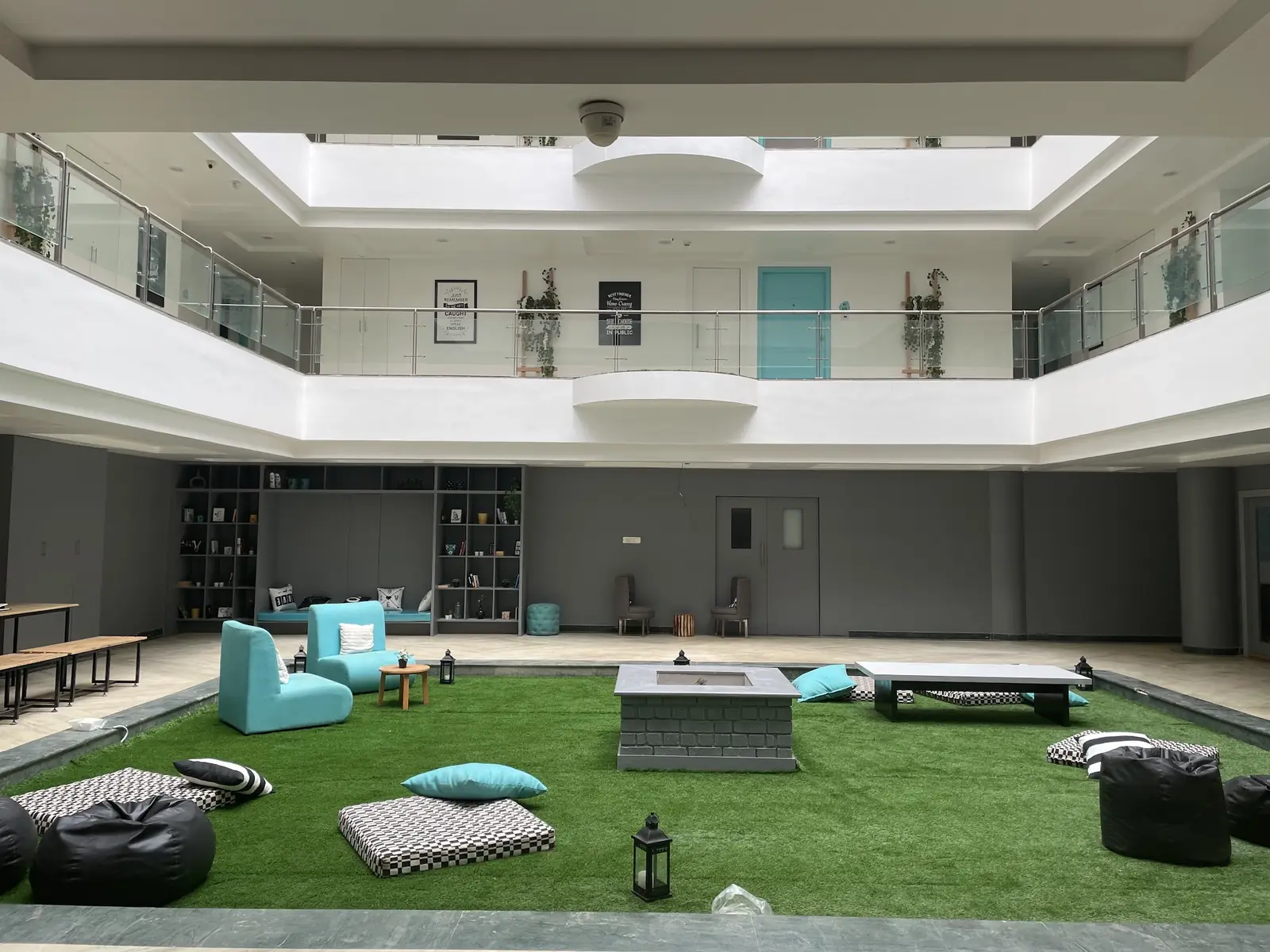 Indoor atrium with a lawn, bean bags and skylights