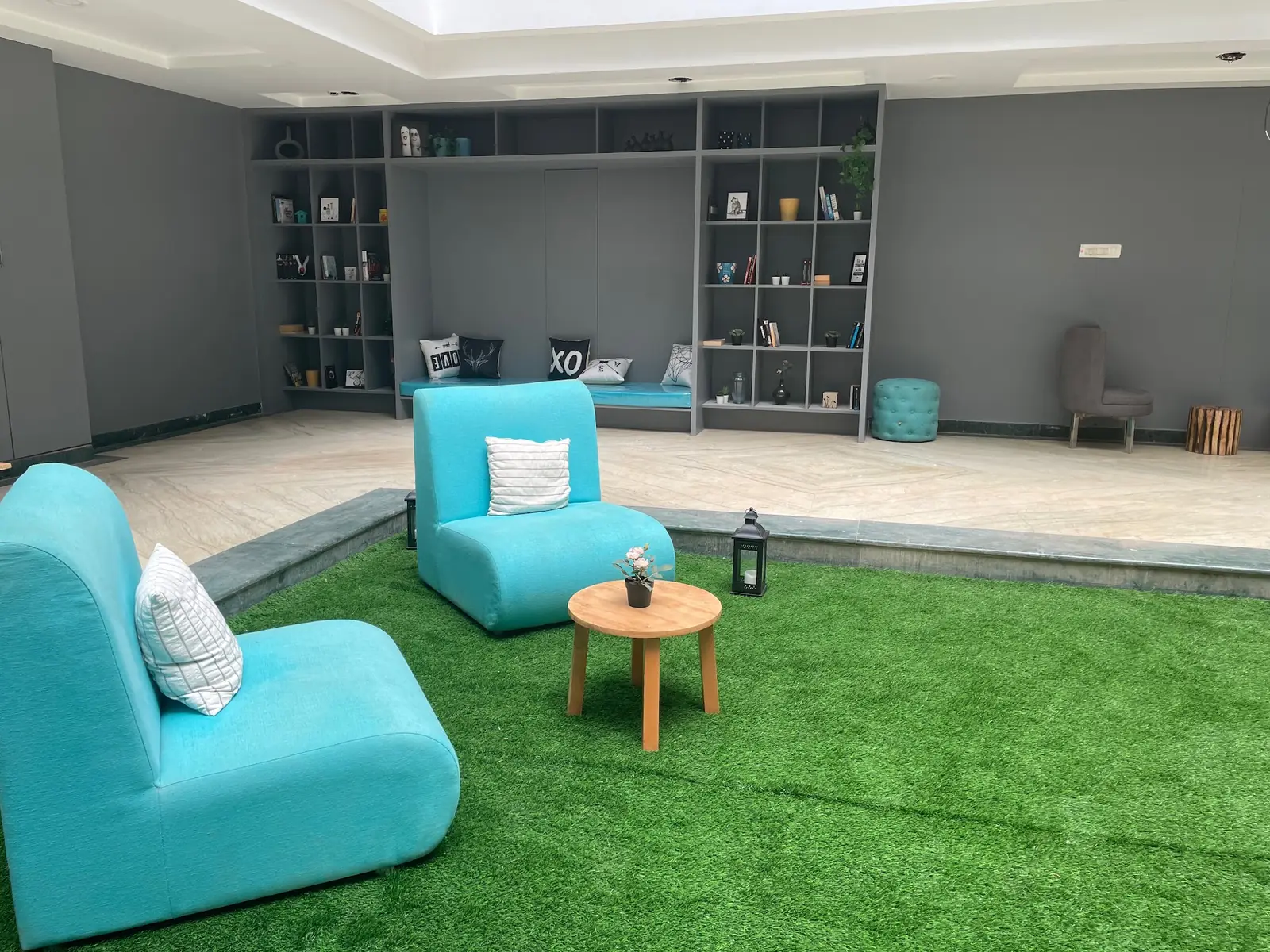 Teal chairs on the indoor lawn
