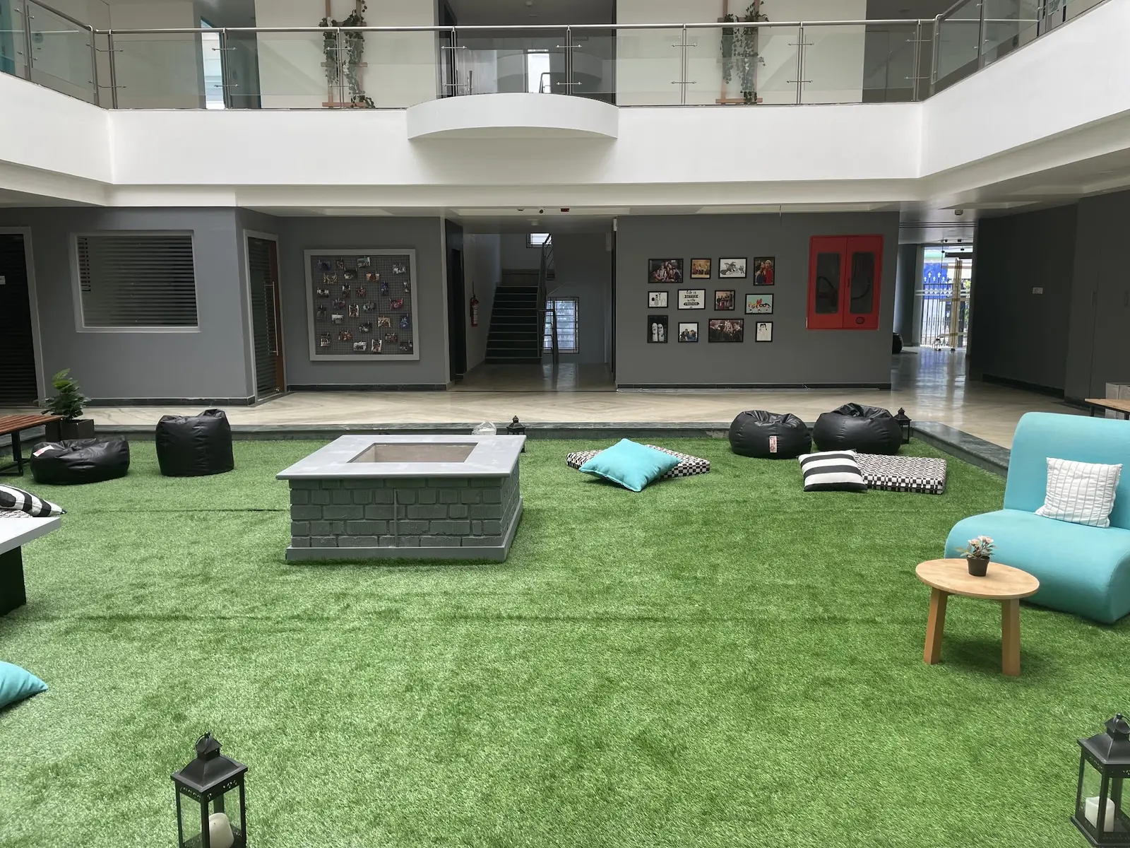 Indoor lawn with a fire pit and bean bags