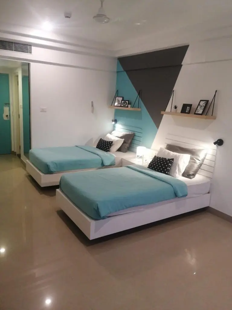 Twin room with teal linen