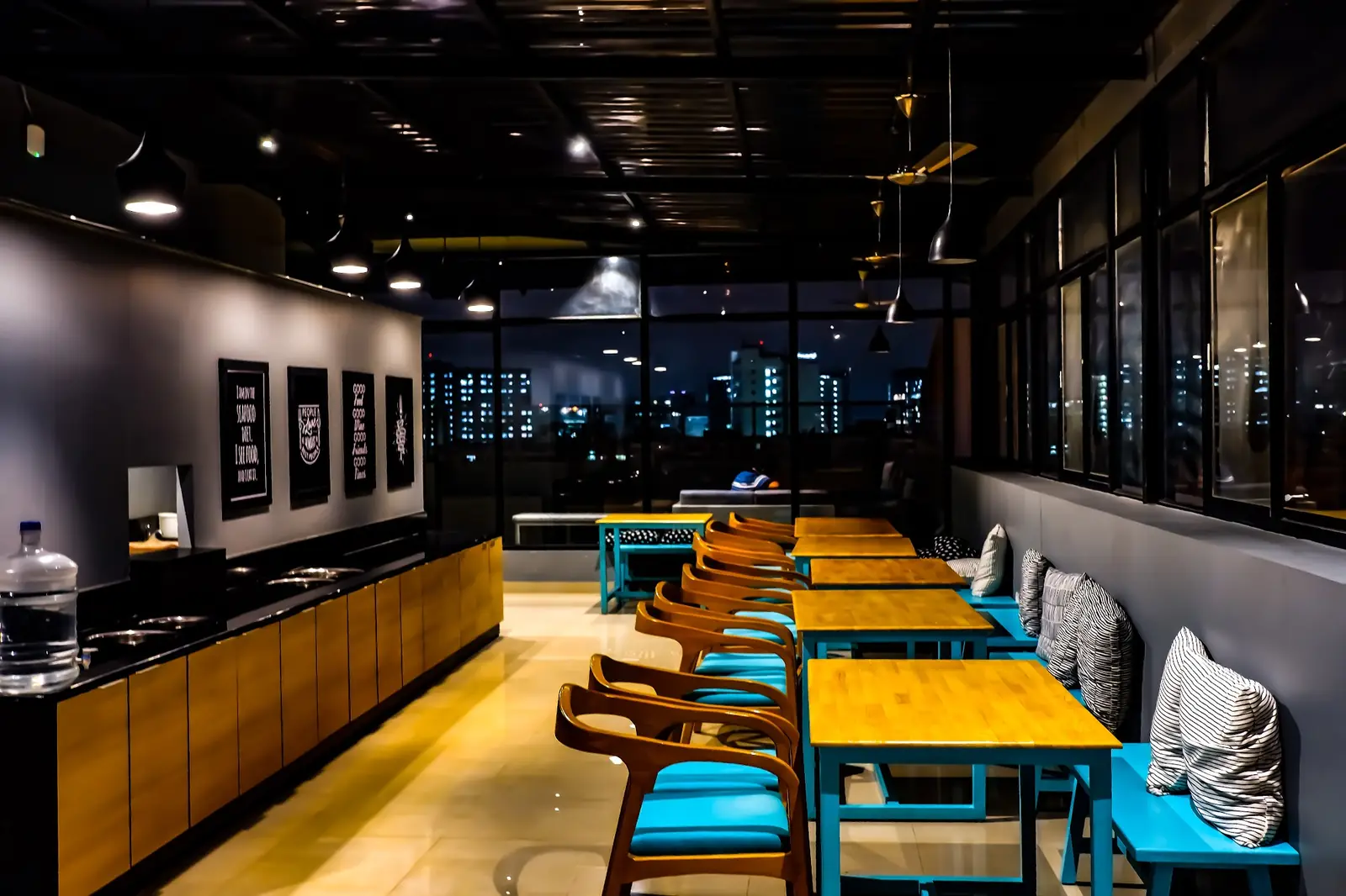 Dining hall with yellow tables at night