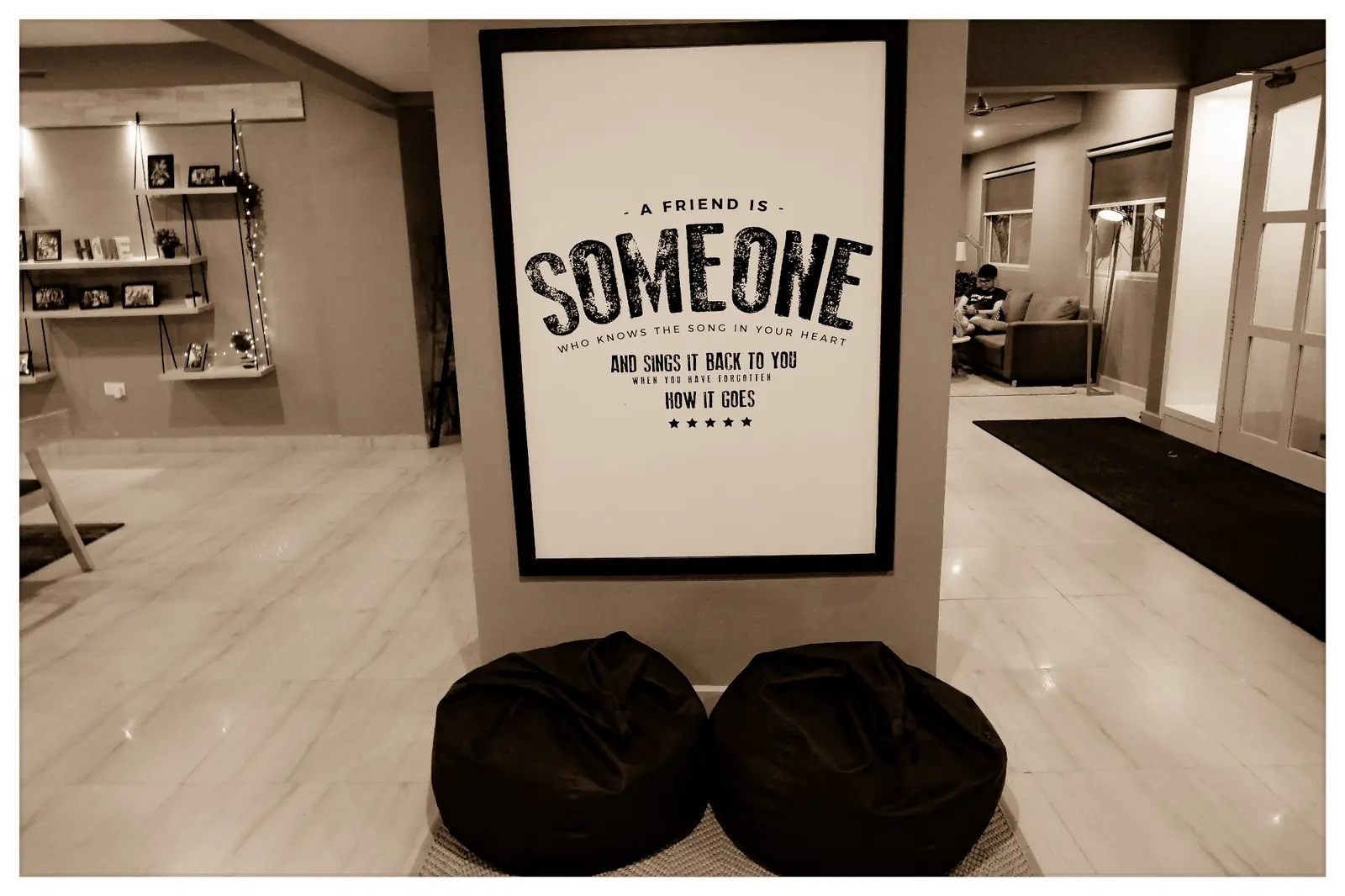 "A friend is someone" poster above bean bags