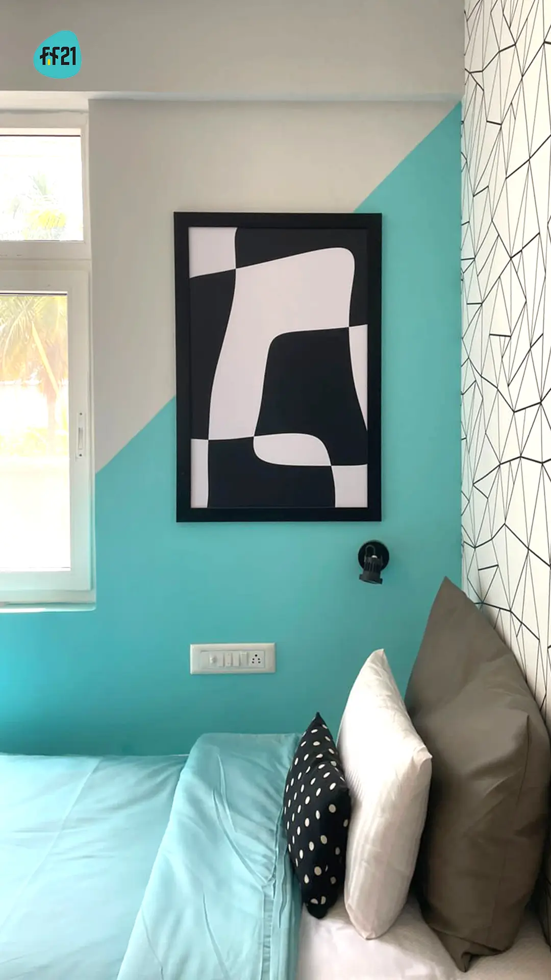 Black and white abstract print on a teal wall