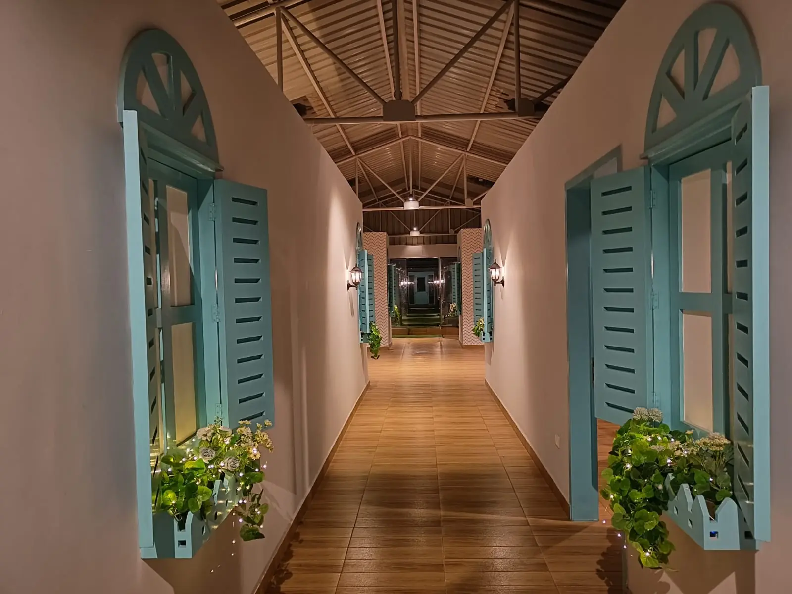 Long corridor with arched teal doors