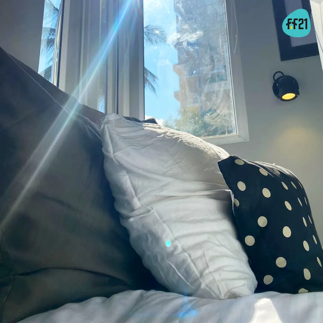 Patterned cushions on a made bed