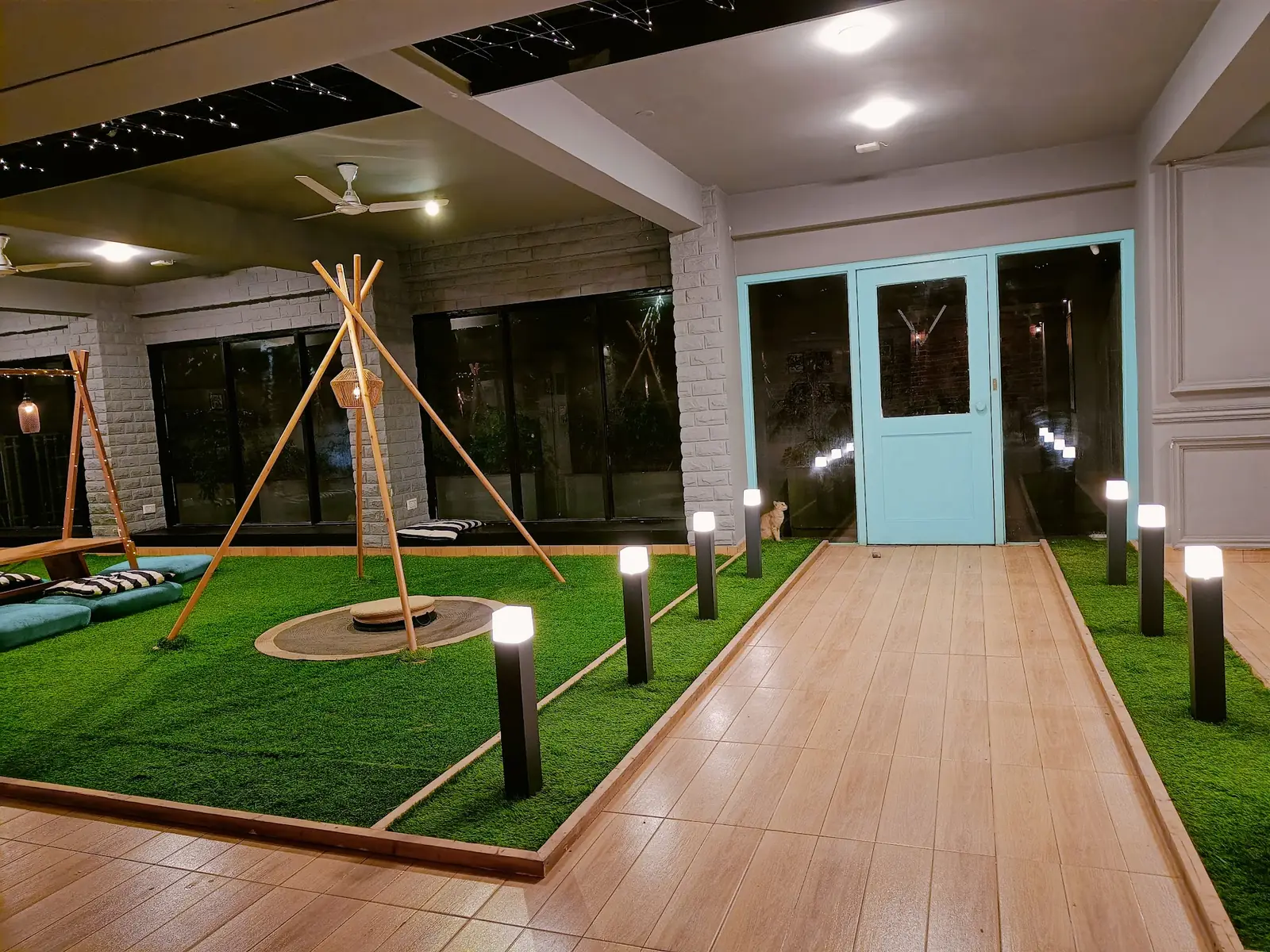 Indoor lawn with lamps and a teepee