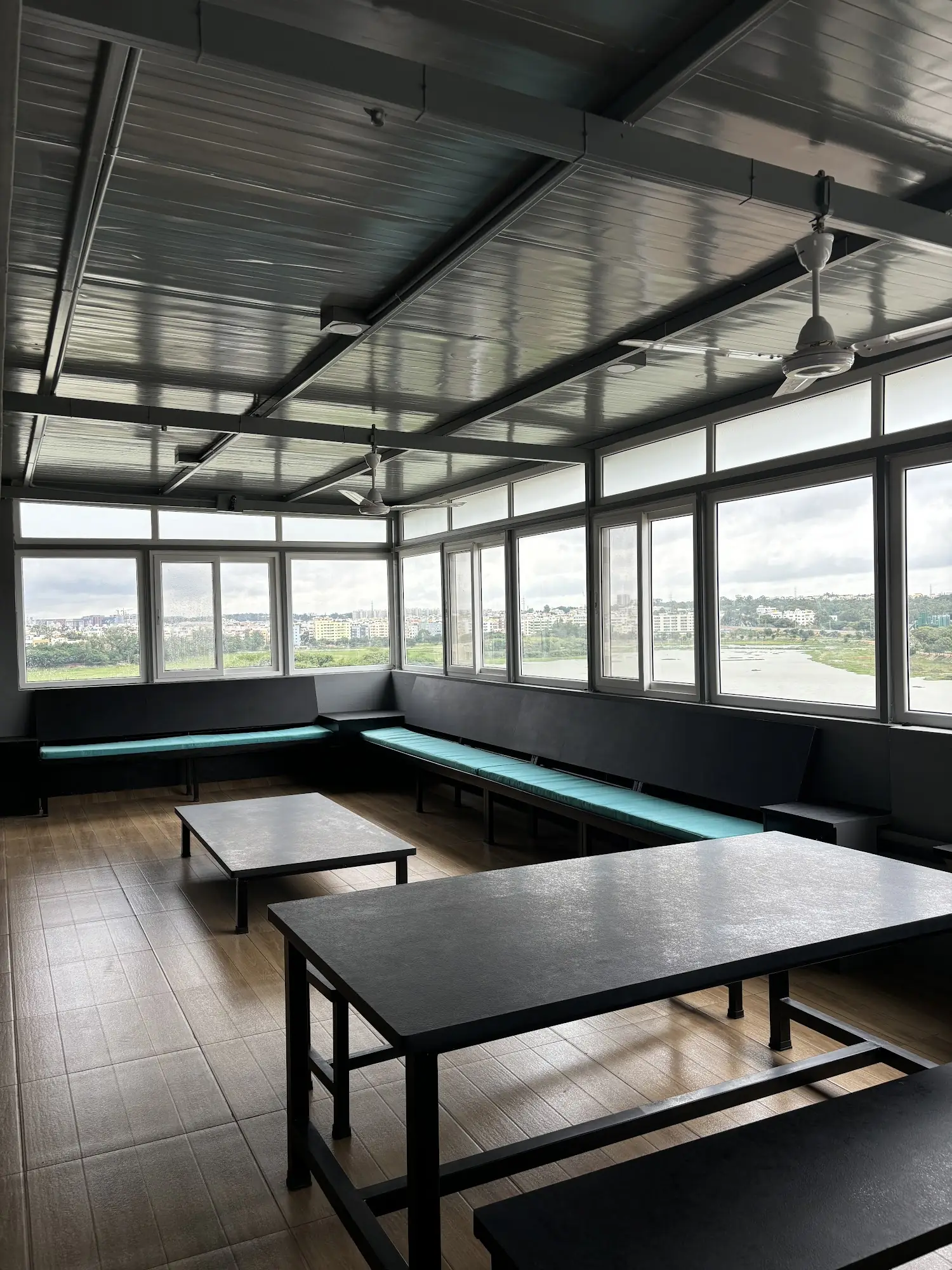 Sunlit lounge with long built-in seating and a city view