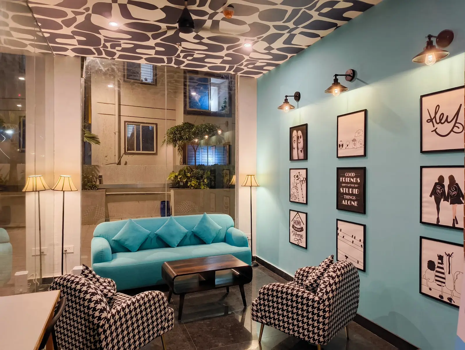 Lobby lounge with a teal sofa and framed prints