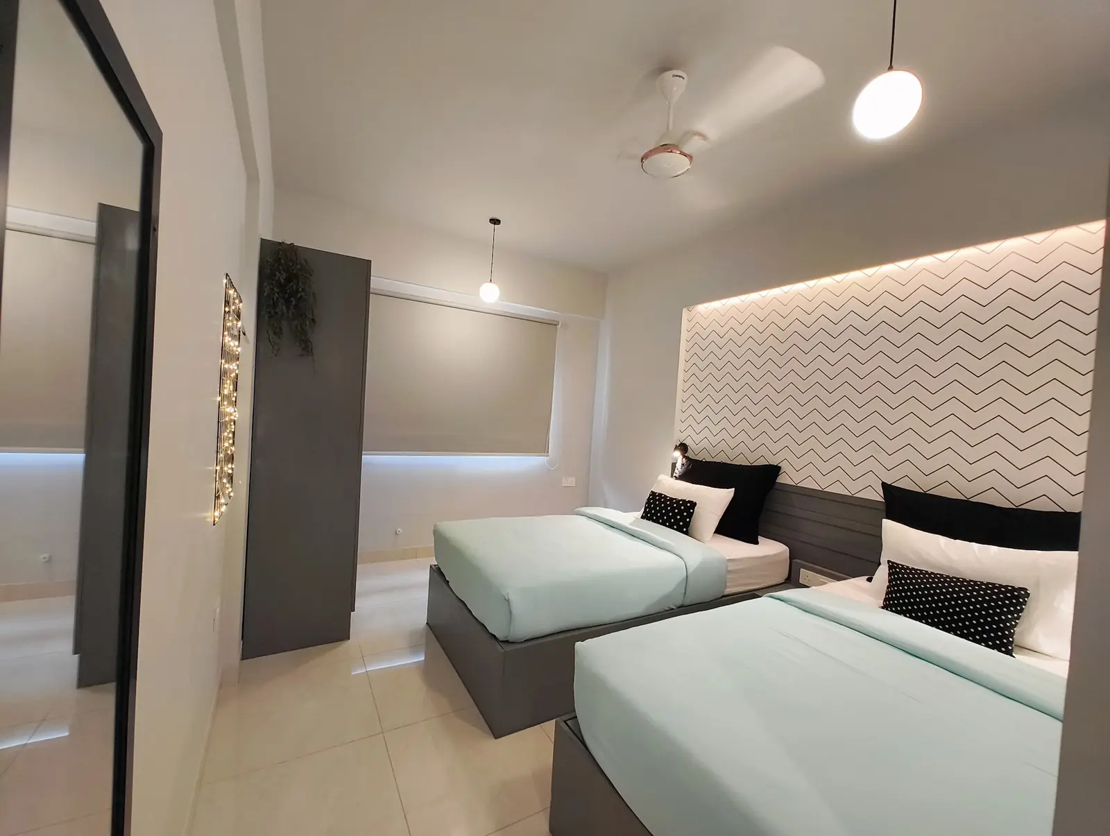 Twin room with two beds and a chevron wall